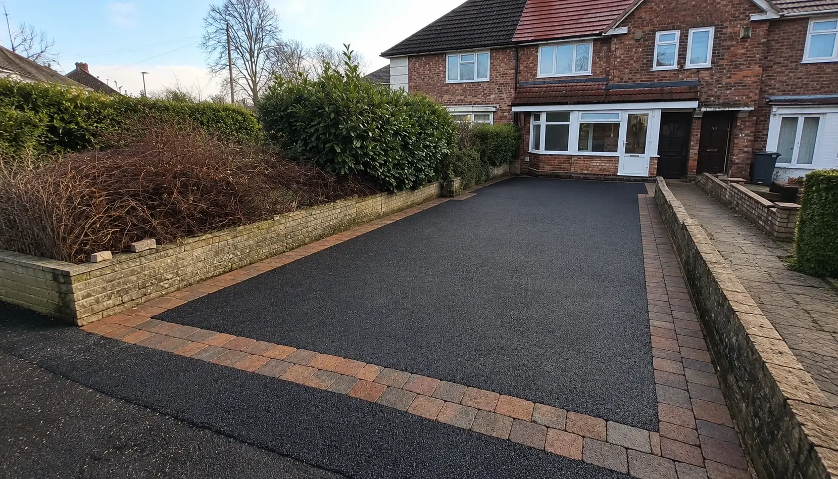 Newly completed tarmac driveways with block paving border at a residential property in Soham near Ely, Cambridgeshire.