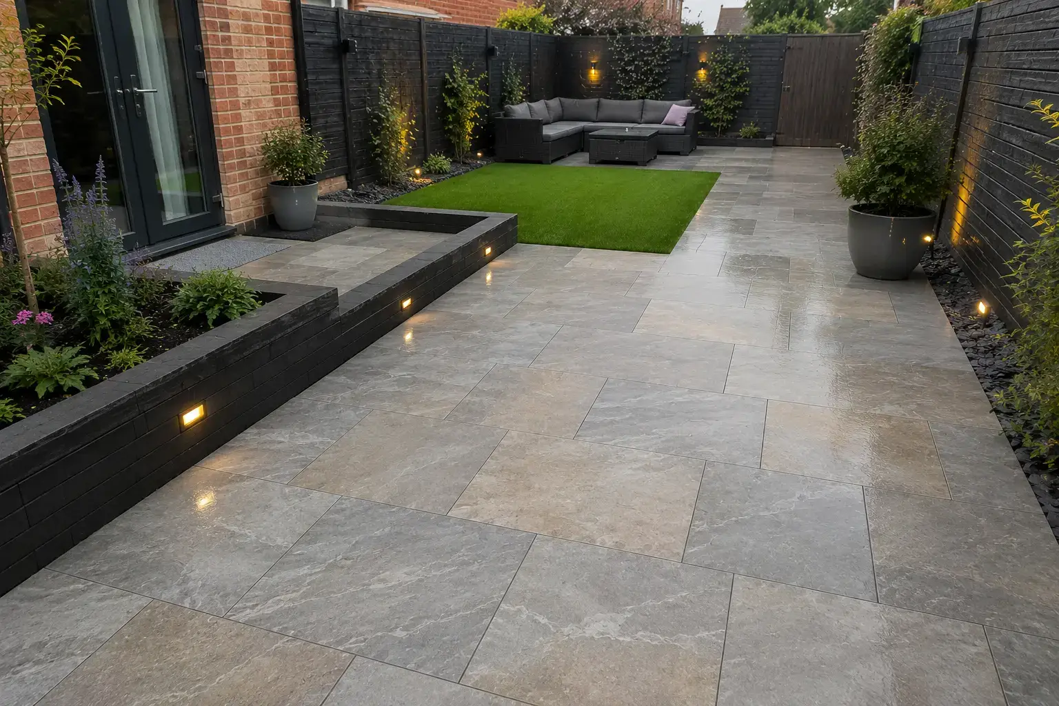Kandla grey porcelain patio with raised borders and garden seating in Ely